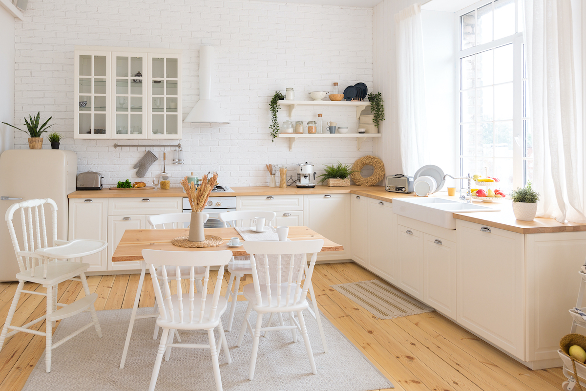 cute cozy light interior design of the apartment with a free layout of the kitchen and bedroom areas. a lot of windows, a wooden floor and a hanging swing.
